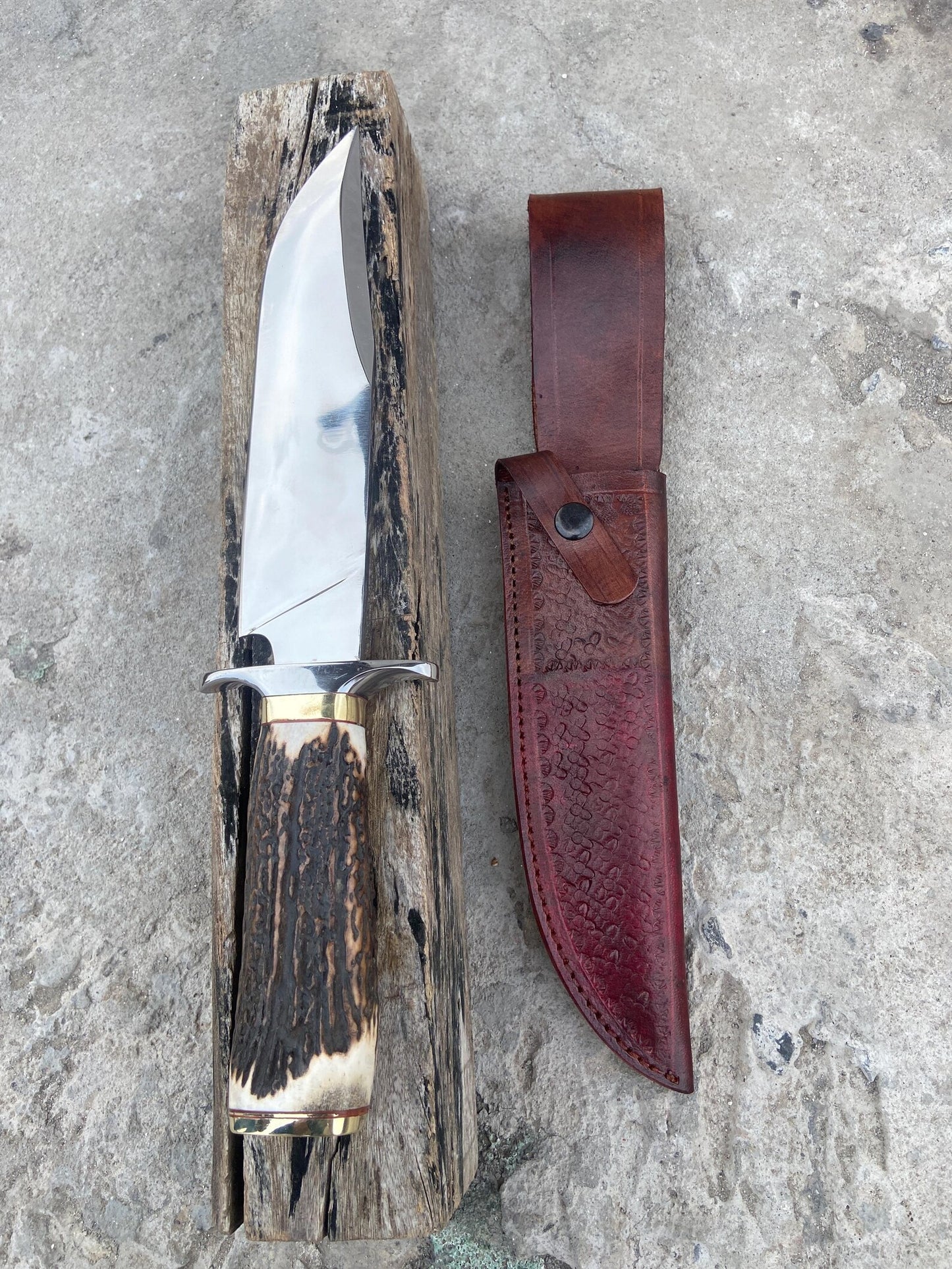 Outdoor hunting Bowie knife showing its natural material handle and slim pointed spine design for precise cutting and balance.