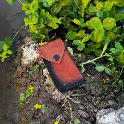 Leather sheath for Damascus pocket knife shown separately highlighting handcrafted stitching and protective storage.