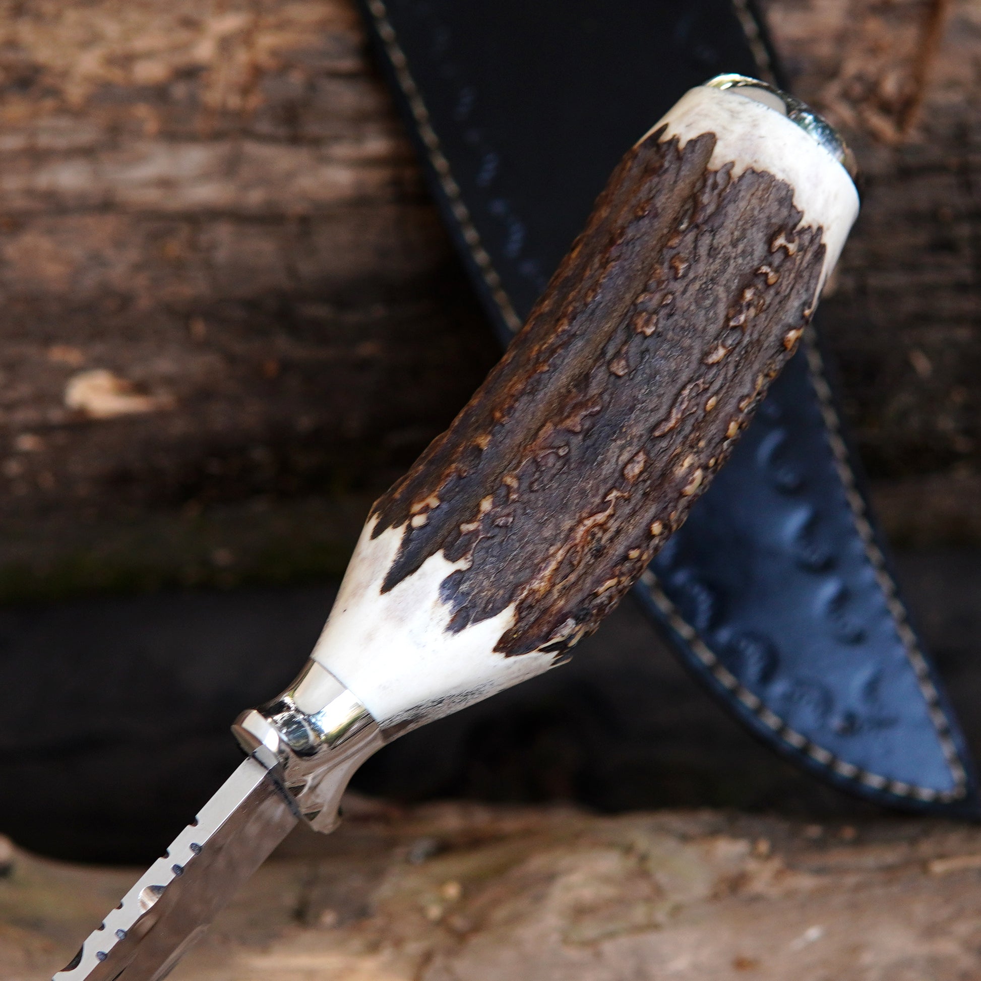 Outdoor survival knife with wide blade profile and strong spine, suitable for camping and hunting use.