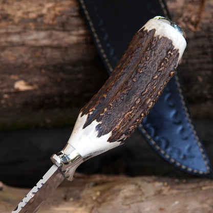 Outdoor survival knife with wide blade profile and strong spine, suitable for camping and hunting use.