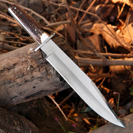 Carbon steel hunting knife with deep central groove and sharp clip point blade design.
