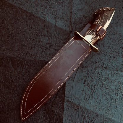 Large Bowie knife ideal for outdoor survival, showcasing hand-forged carbon steel blade and ergonomic stag grip.