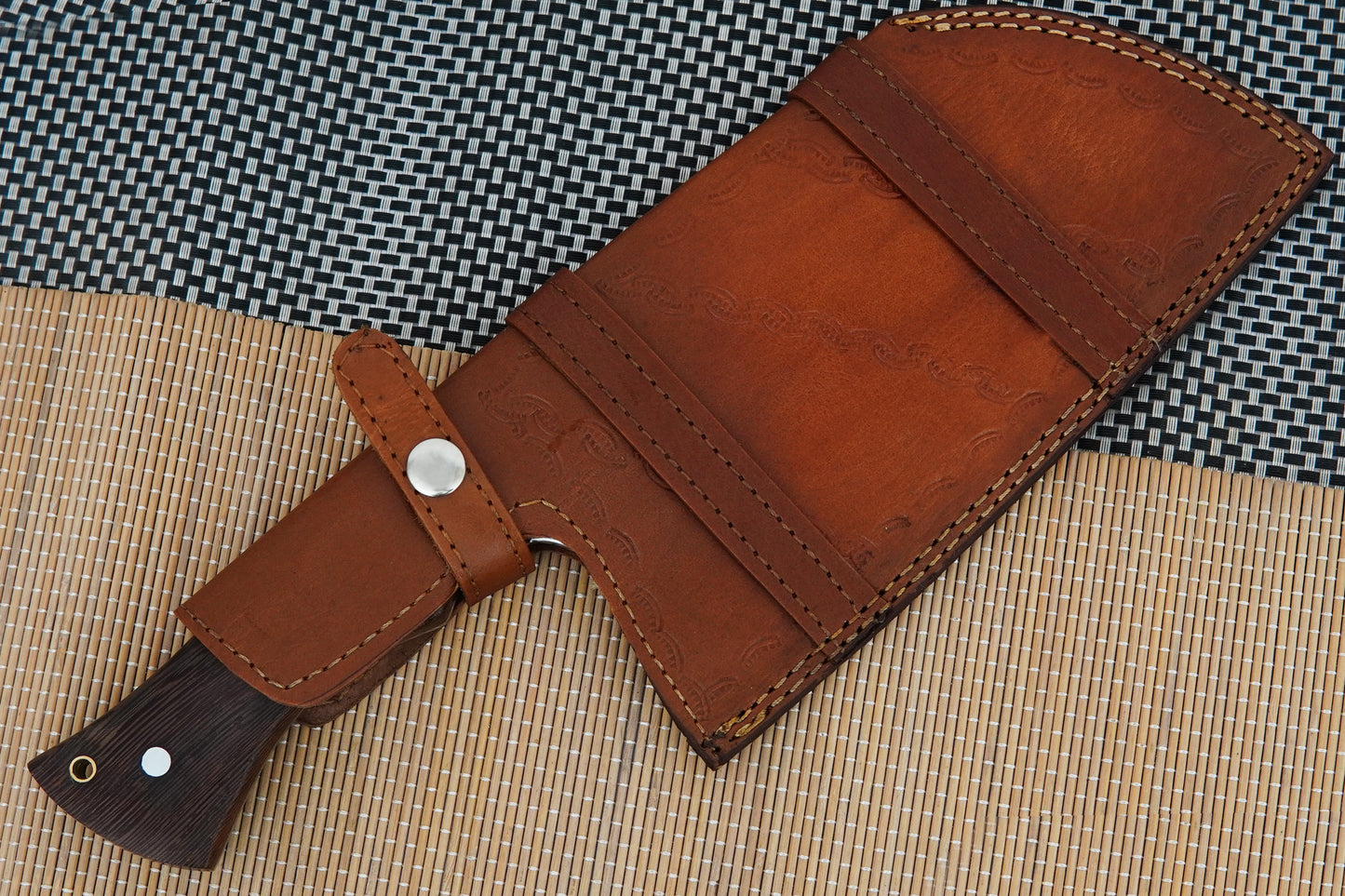 This outdoor meat cleaver is handmade from Damascus steel with a solid full tang construction and natural wenge wood handle. A versatile knife for camping, BBQ, or kitchen use. Each piece is unique and includes free personalisation.