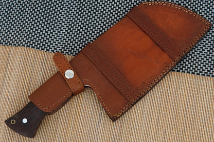 This outdoor meat cleaver is handmade from Damascus steel with a solid full tang construction and natural wenge wood handle. A versatile knife for camping, BBQ, or kitchen use. Each piece is unique and includes free personalisation.