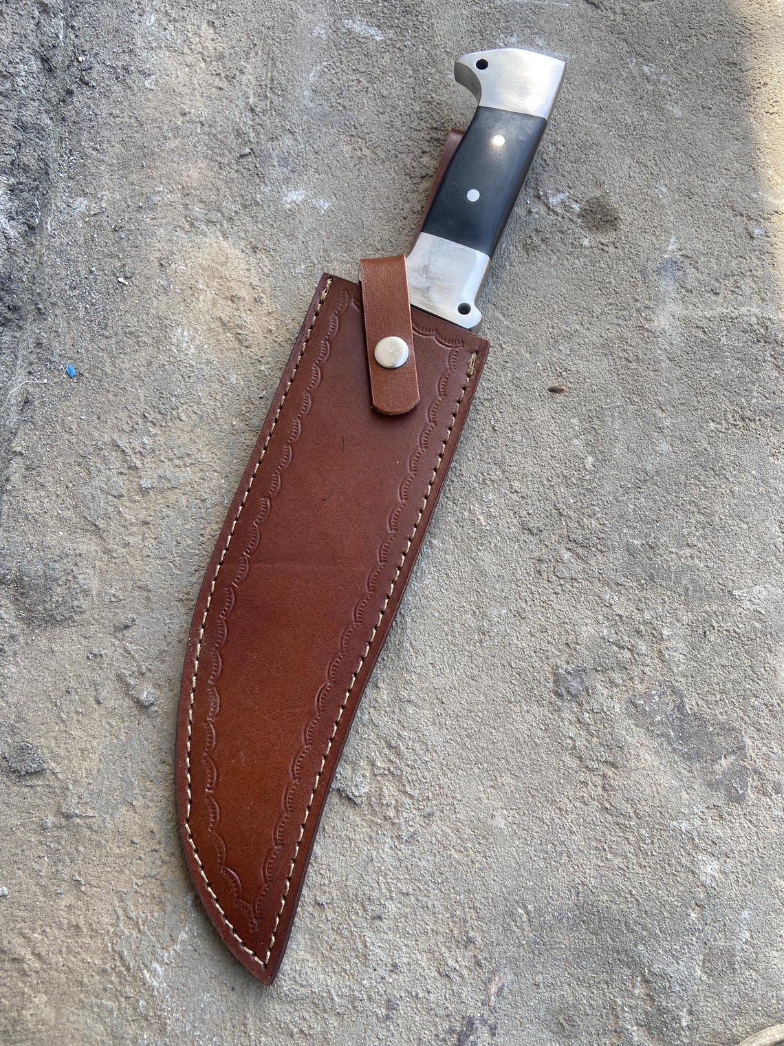 Full tang outdoor knife with strong handle grip and high-carbon steel blade.
