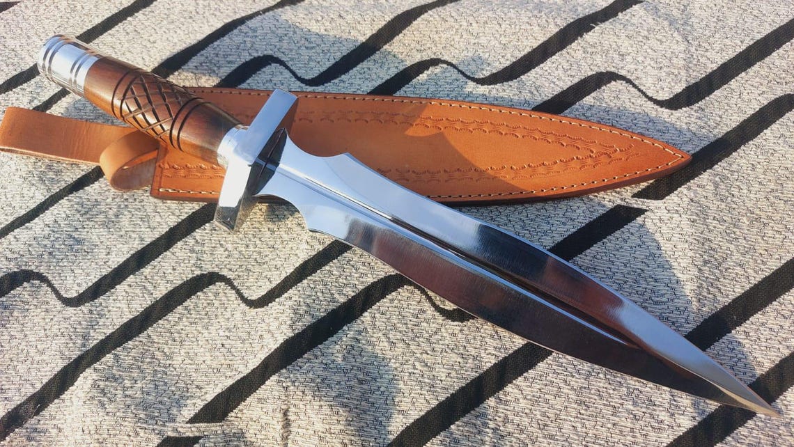 Handmade large dagger knife with polished steel blade and wooden handle.