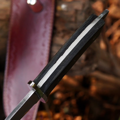 Close-up of a polished steel blade bowie knife with strong spine and refined finish.