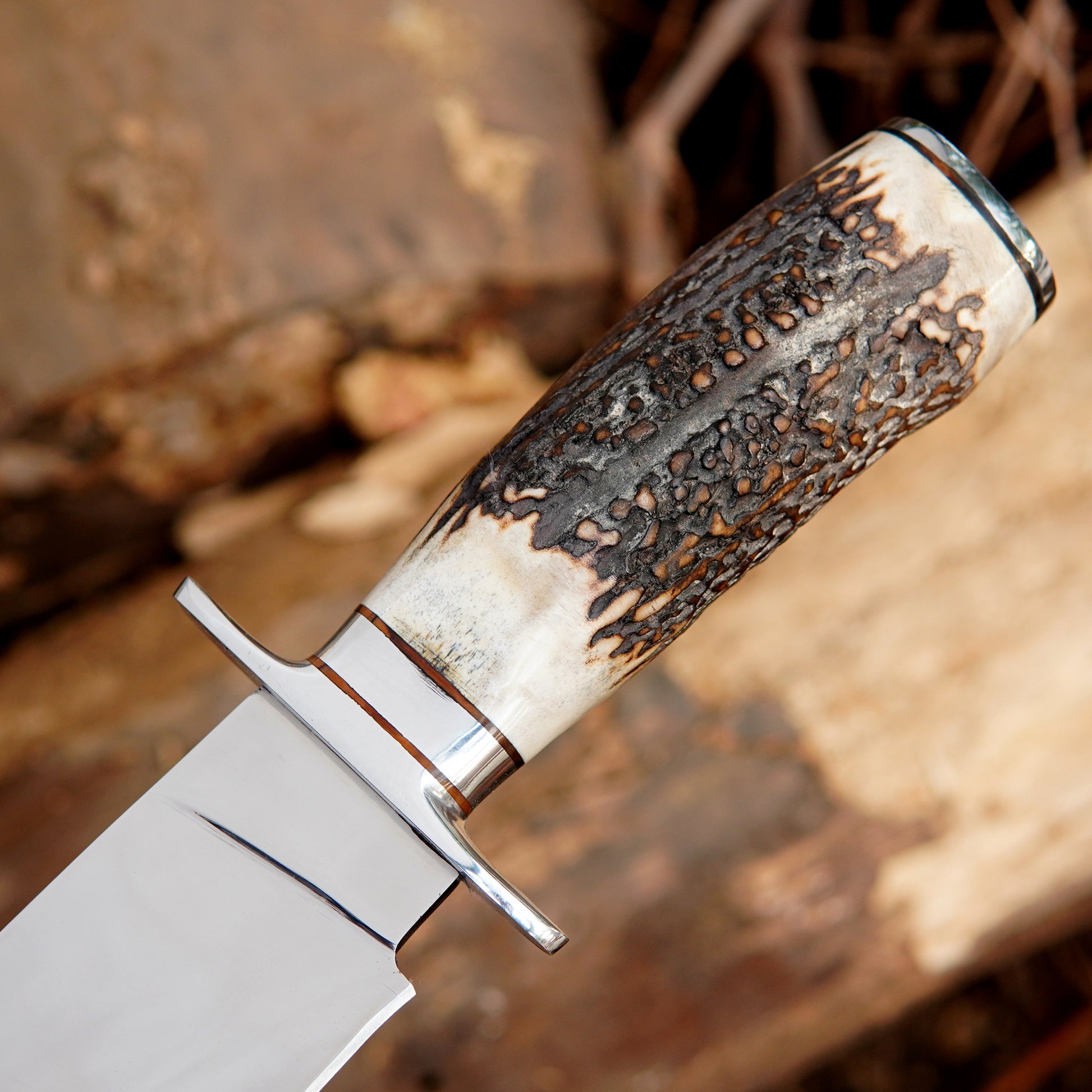 Detailed handle closeup of handmade bowie knife highlighting grip shape and smooth finishing. The image emphasizes comfort, balance, and handmade character, helping buyers understand the quality of materials and the practical design suited for long outdoor use.