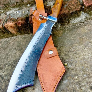 Handmade carbon steel machete knife with large Bowie-style blade and rosewood handle for hunting and camping use.