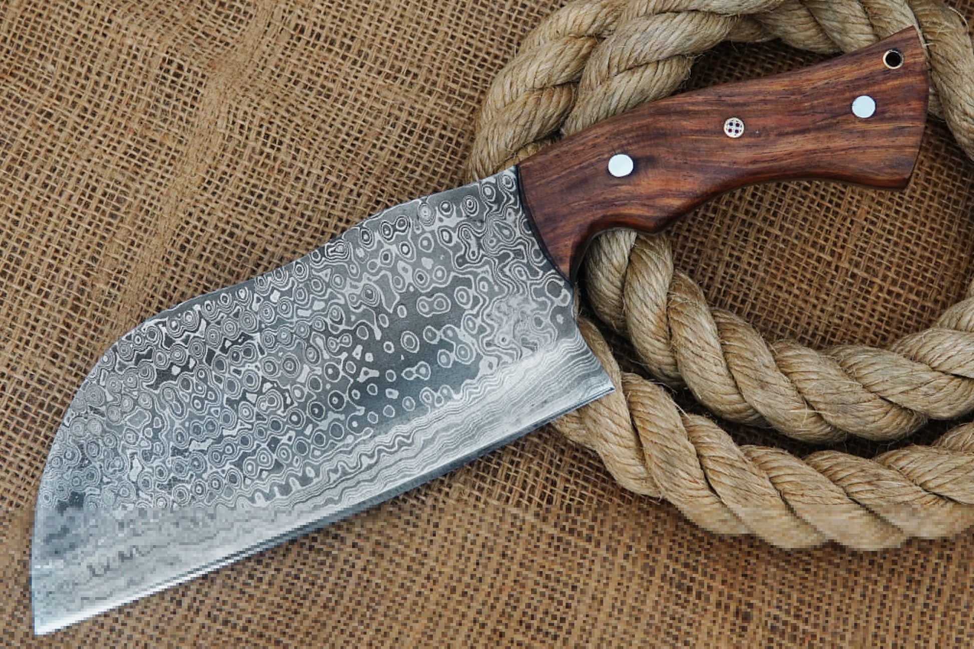A Serbian cleaver built from Damascus steel with full tang construction and a smooth rose wood handle. Strong, balanced, and stylish, this knife is suitable for kitchen chopping or outdoor use. Free engraving adds a custom touch.