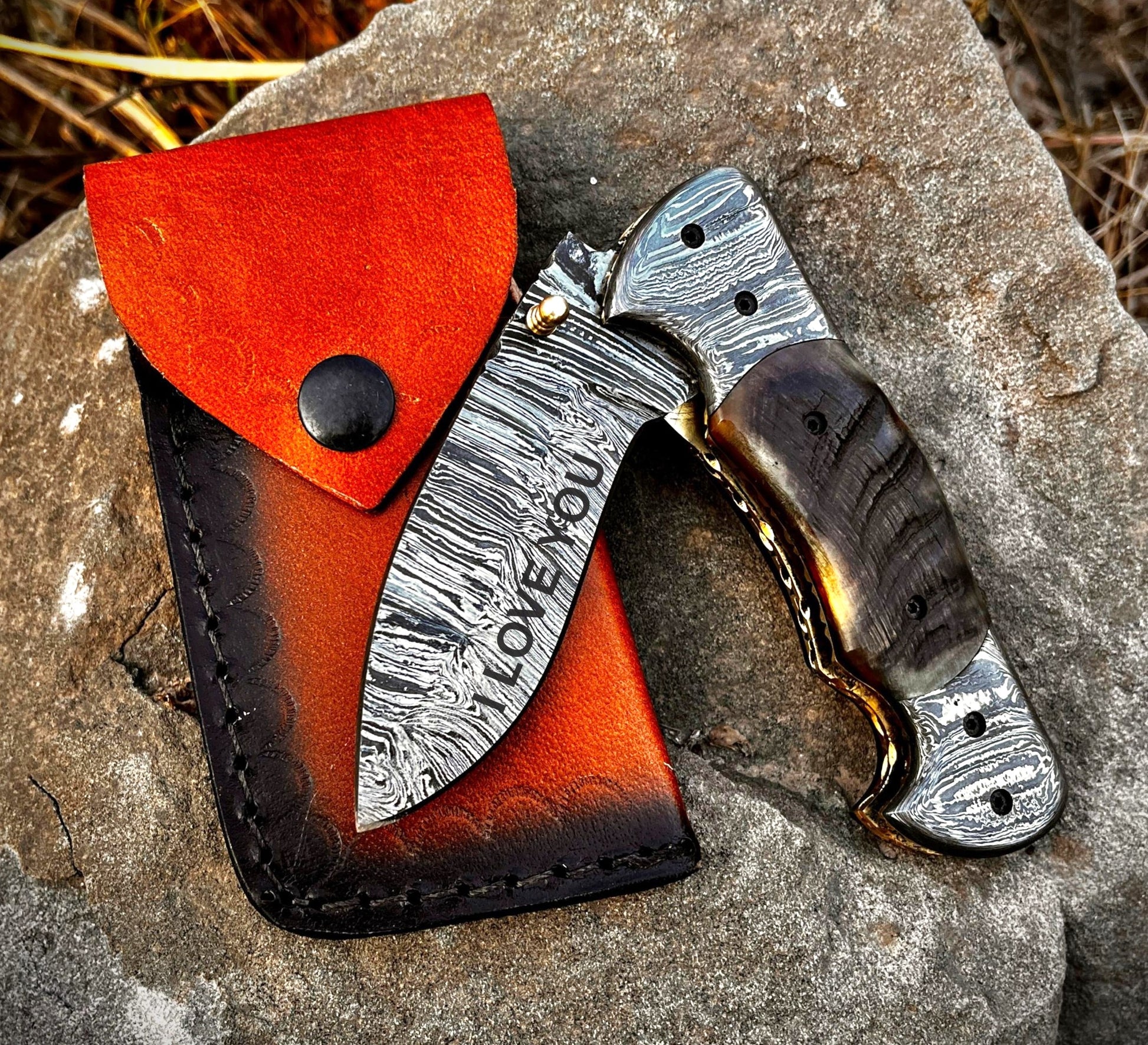 Custom engraved pocket knife demonstrating personalization options on blade and leather sheath making it a thoughtful custom gift.