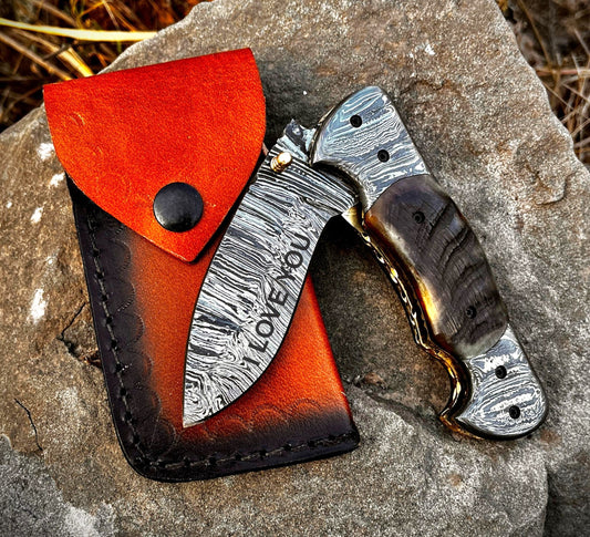 Custom engraved pocket knife demonstrating personalization options on blade and leather sheath making it a thoughtful custom gift.